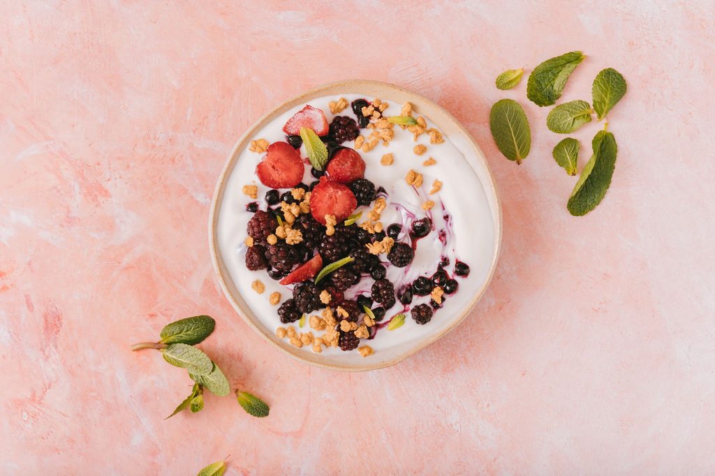 A high-protein breakfast bowl of Greek yogurt topped with fresh berries and seeds